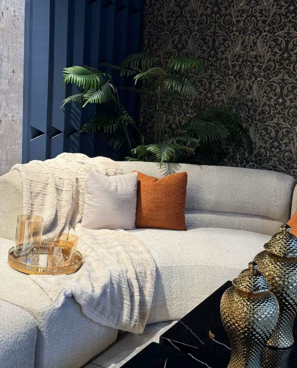 A modern living room furnished with a custom sofa and accent pieces
